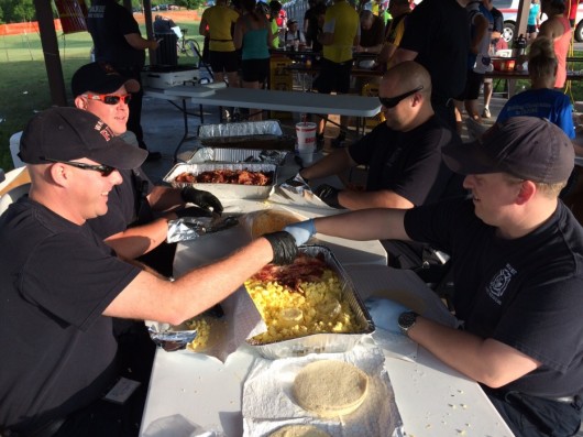 Members of the Waukee Fire Department man the bacon breakfast burrito assembly line Saturday morning. 