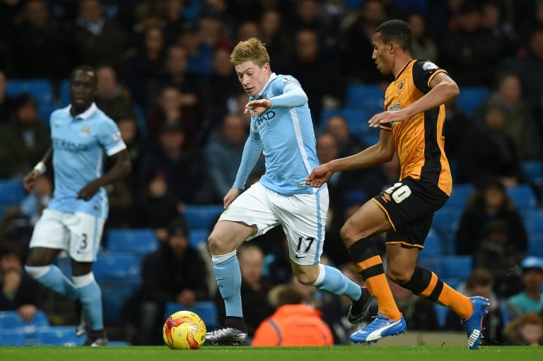 Manchester City's midfielder Kevin De Bruyne (C) is tracked by Hull City's defender Isaac Hayden during an English League Cup quarter-final football match at the Etihad Stadium on December 1, 2015