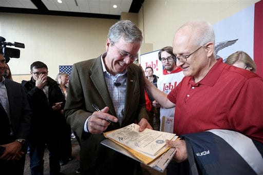 Republican presidential candidate, former Florida Gov. Jeb Bush signs an autograph for Tim Nass during a campaign stop at the University of Dubuque's Heritage Center on Tuesday, Dec. 1, 2015 in Dubuque, Iowa.  (Jessica Reilly/Telegraph Herald via AP) MANDATORY CREDIT